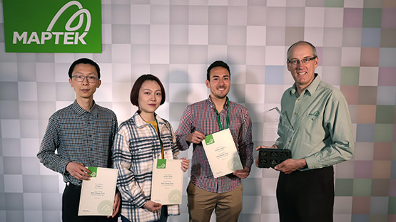 Steve Sullivan presenting University of Adelaide mining engineering students Cheng Li, Yixuan Xiang and Claudio Wiehe Jr with the 2021 Maptek Mine Design Prize.